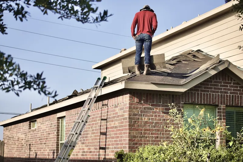 Professional roofer working on a residential roof in Las Casas